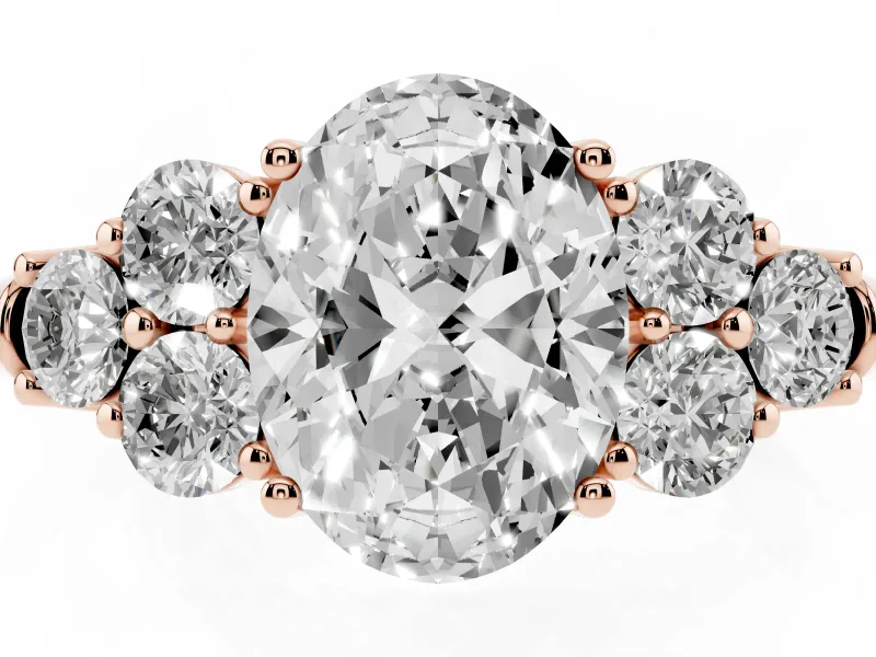 Oval Cut Diamond Cluster Ring Set in Rose gold with Round Accent Stones and Prong Setting on a Plain Band