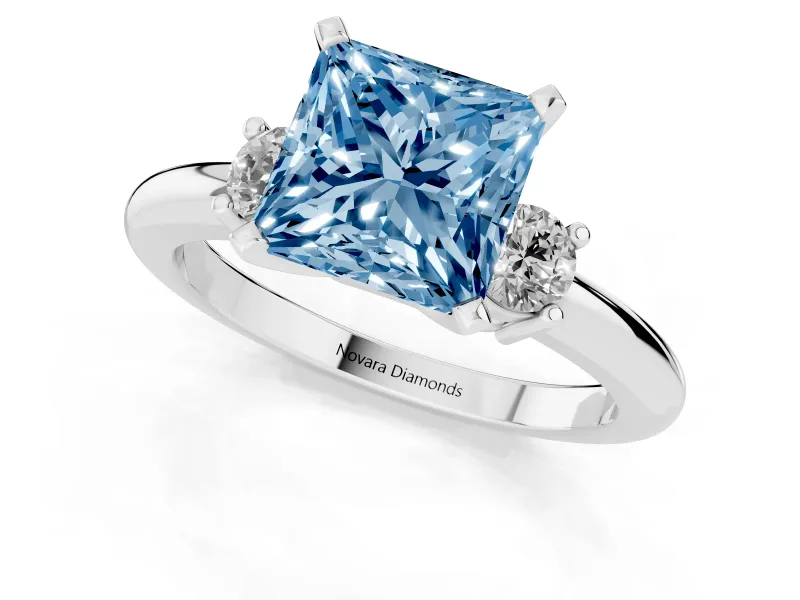 Fancy Blue Three-Stone Princess Cut Diamond Ring Set in Platinum with Prong Setting and Plain Band
