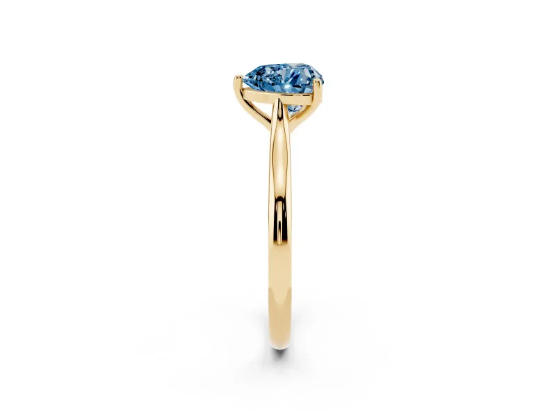 Fancy Blue Heart Cut Diamond Solitaire Ring Set in Yellow gold with Cathedral Band and Prong Setting