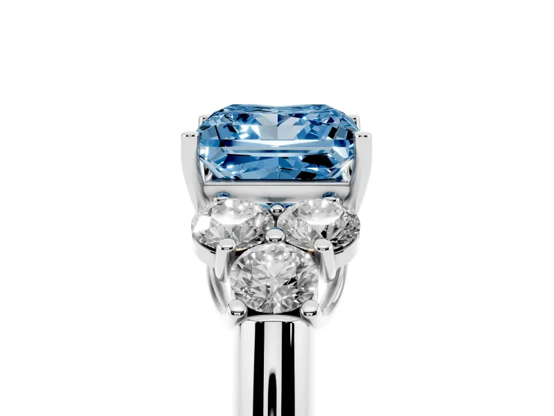 Fancy Blue Princess Cut Diamond Cluster Ring Set in Platinum with Round Accent Stones and Prong Setting on a Plain Band