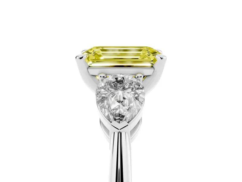 Fancy Yellow Three-Stone Emerald Cut Diamond Ring Set in White gold with Pear Side Stones and Prong Setting