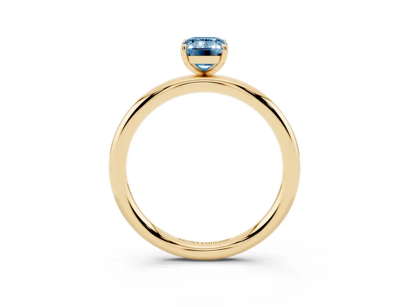 Fancy Blue Emerald Cut Diamond Solitaire Ring Set in Yellow gold with Prong Setting on a Polished Plain Band