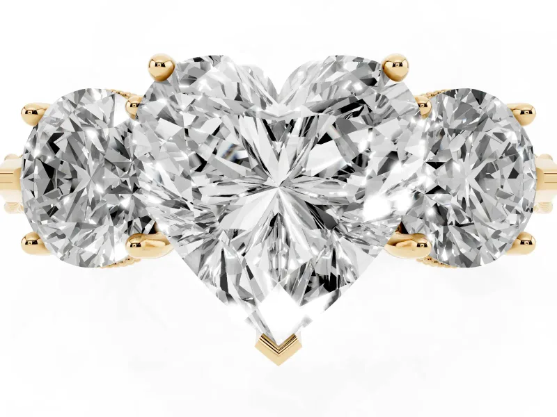 Heart Cut Diamond Three-Stone Ring Set in Yellow gold with Milgrain Band