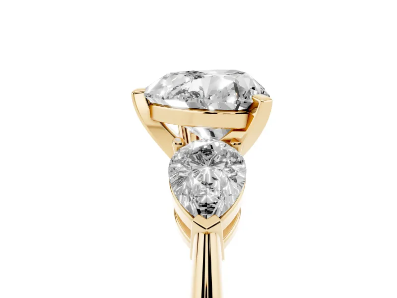 Three-Stone Heart Cut Diamond Ring Set in Yellow gold with Pear Side Stones and Prong Setting