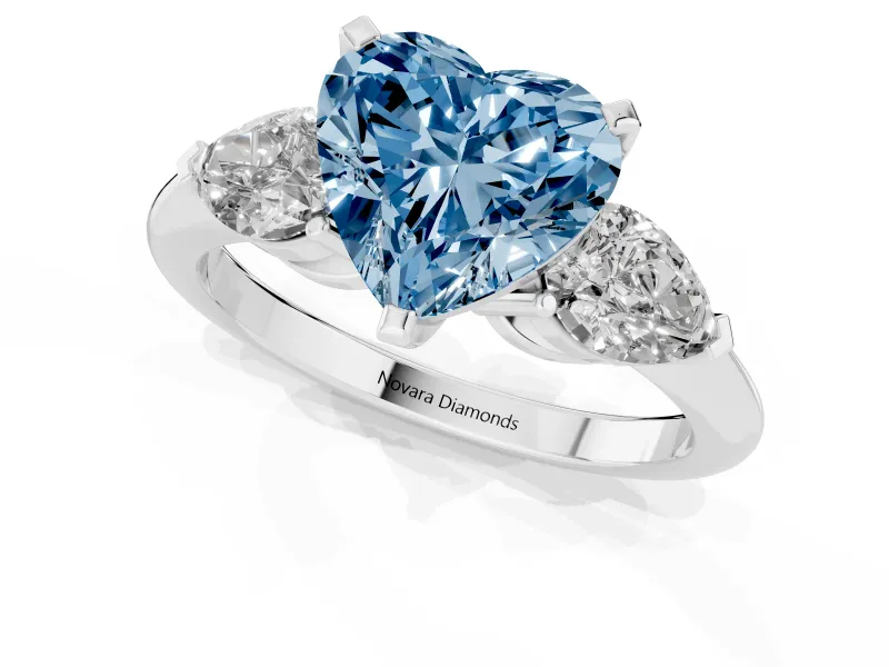 Fancy Blue Three-Stone Heart Cut Diamond Ring Set in White gold with Pear Side Stones and Prong Setting