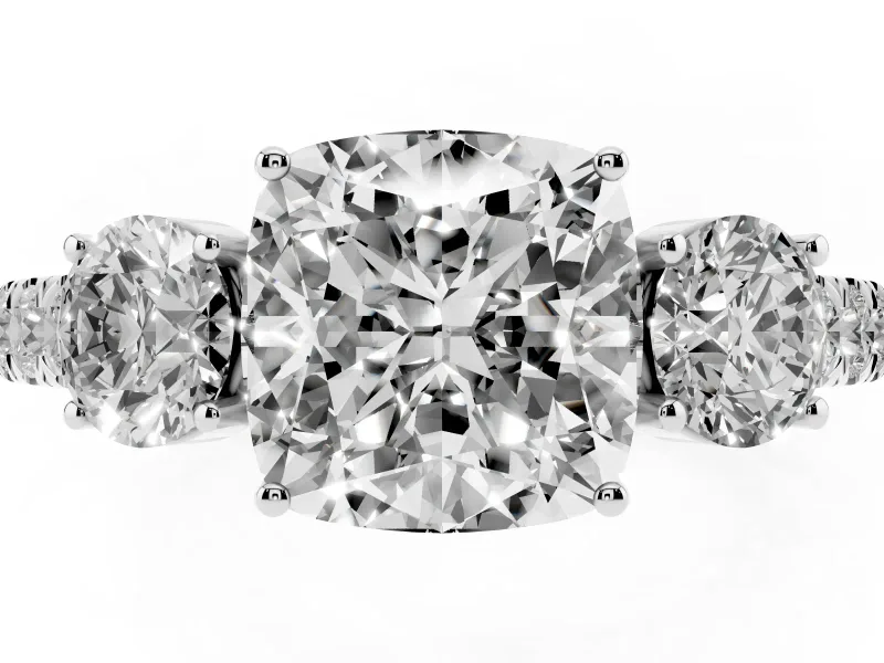 Cushion Cut Diamond Three-Stone Ring Set in White gold with Round Side Stones and Delicate Pavé Band