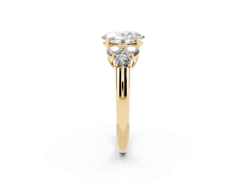 Oval Cut Diamond Cluster Ring Set in Yellow gold with Round Accent Stones and Prong Setting on a Plain Band