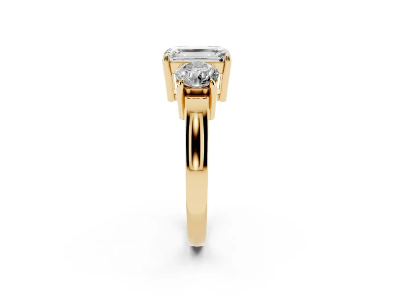 Emerald Cut Diamond Three-Stone Ring Set in Yellow gold with Round Accent Stones and Plain Band
