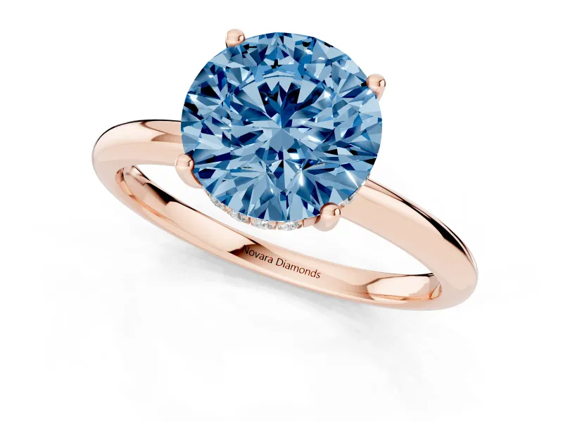 Fancy Blue Round Cut Diamond Solitaire Engagement Ring Set in Rose gold with Prong Setting and Polished Band
