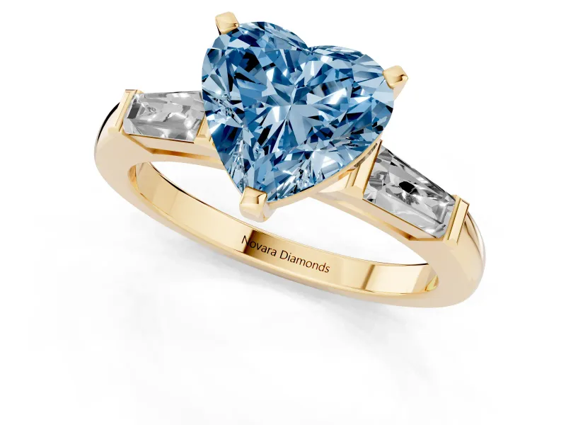 Fancy Blue Heart Cut Diamond Solitaire Ring Set in Yellow gold with Tapered Baguette Side Stones and Prong Setting