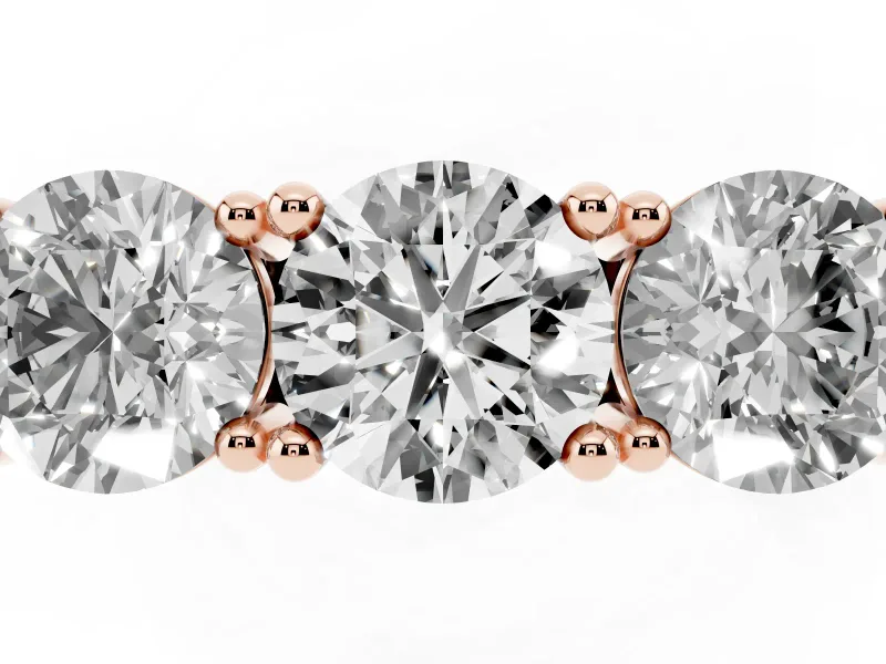 Round Cut Diamond Three-Stone Ring Set in Rose gold with Channel Band and Sturdy Prongs