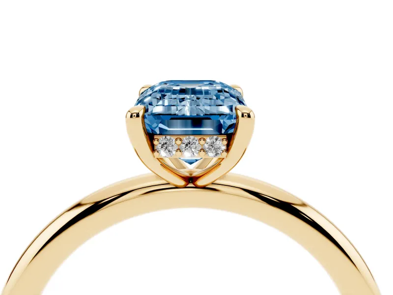 Fancy Blue Emerald Cut Diamond Solitaire Ring Set in Yellow gold with Thin Band and Prong Setting