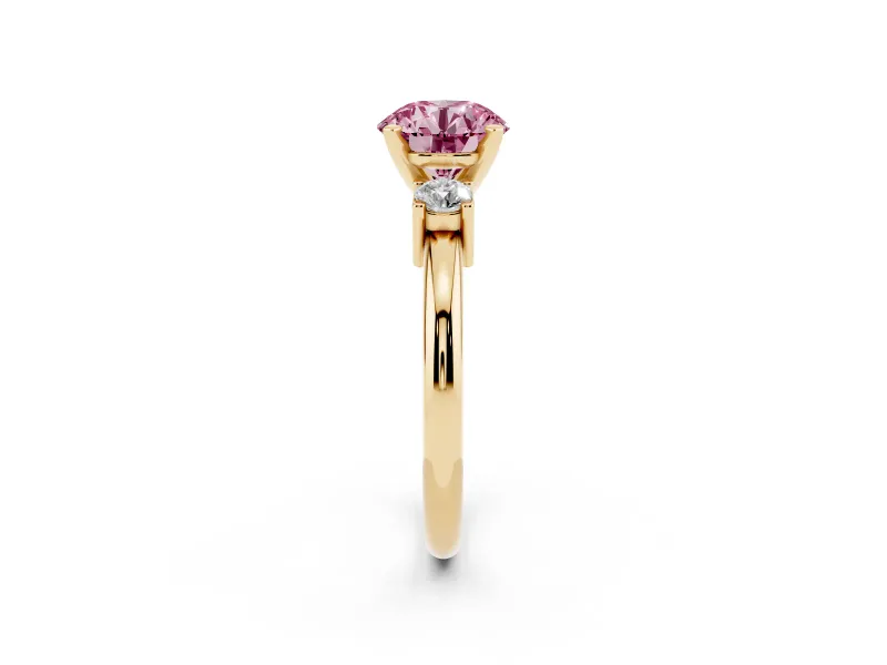 Fancy Pink Three-Stone Round Cut Diamond Ring Set in Yellow gold with Prong Setting and Plain Band