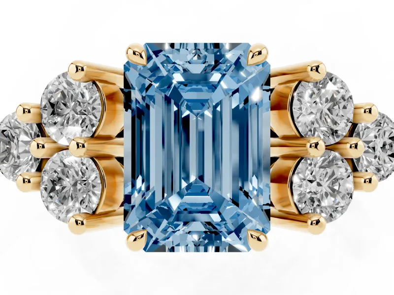 Fancy Blue Emerald Cut Diamond Solitaire Ring Set in Yellow gold with Cluster Accents on Each Side