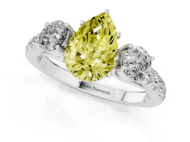 Fancy Yellow Pear Cut Diamond Three-Stone Ring Set in Platinum with Round Side Stones and Delicate Pavé Band