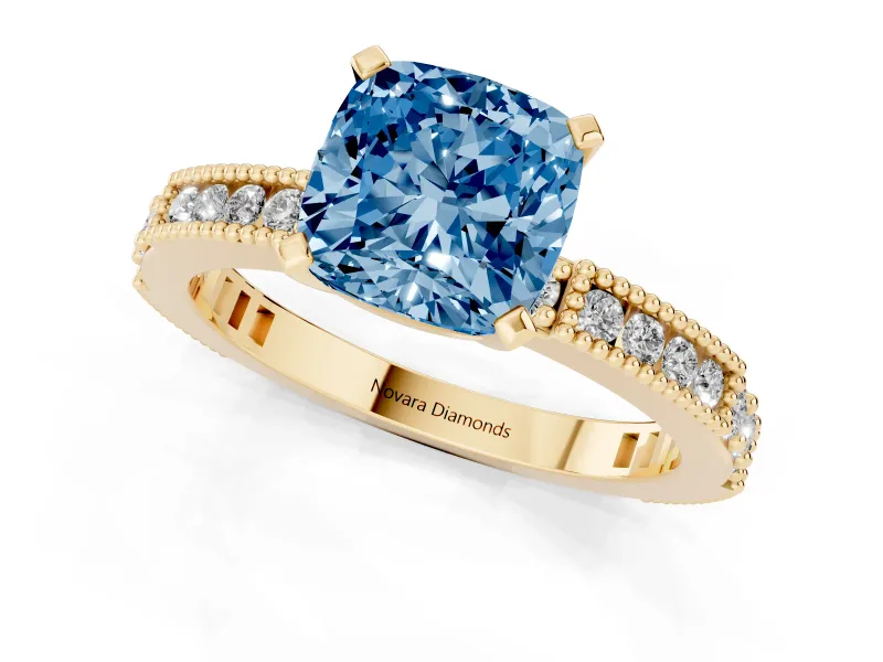 Fancy Blue Cushion Cut Diamond Solitaire Ring Set in Yellow gold with Slim Pavé Band and Prong Setting