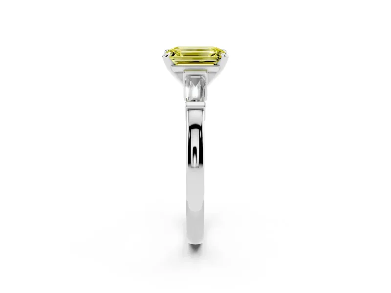 Fancy Yellow Emerald Cut Diamond Solitaire Ring Set in Platinum with Tapered Baguette Accents and Prong Setting