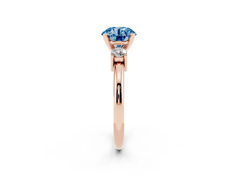 Fancy Blue Three-Stone Round Cut Diamond Ring Set in Rose gold with Prong Setting and Plain Band