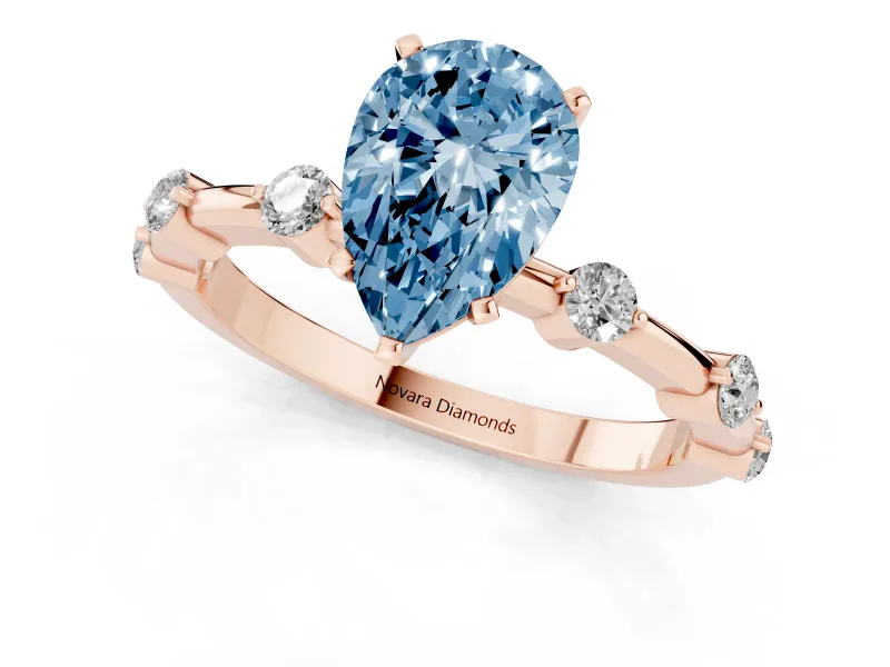Fancy Blue Pear Cut Diamond Solitaire Ring Set in Rose gold with Bezel Set Side Stones and Prong Setting