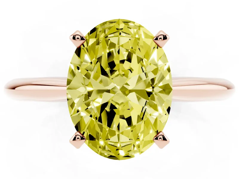 Fancy Yellow Oval Cut Diamond Solitaire Ring Set in Rose gold with Prong Setting on a Plain Round Band