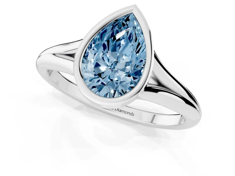 Fancy Blue Bezel Set Pear Cut Diamond Solitaire Ring Set in White gold with Tapered Band