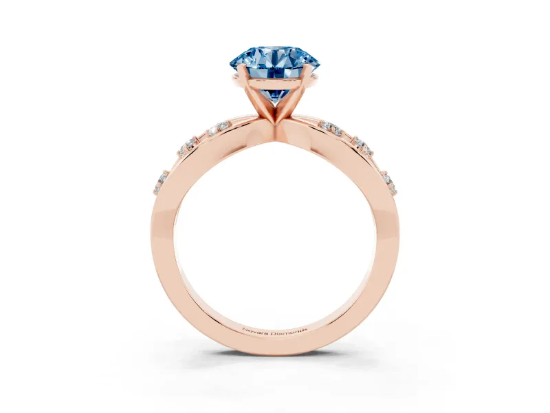Fancy Blue Round Cut Diamond Solitaire Ring Set in Rose gold with Side Stones on Criss-Cross Band and Prong Setting