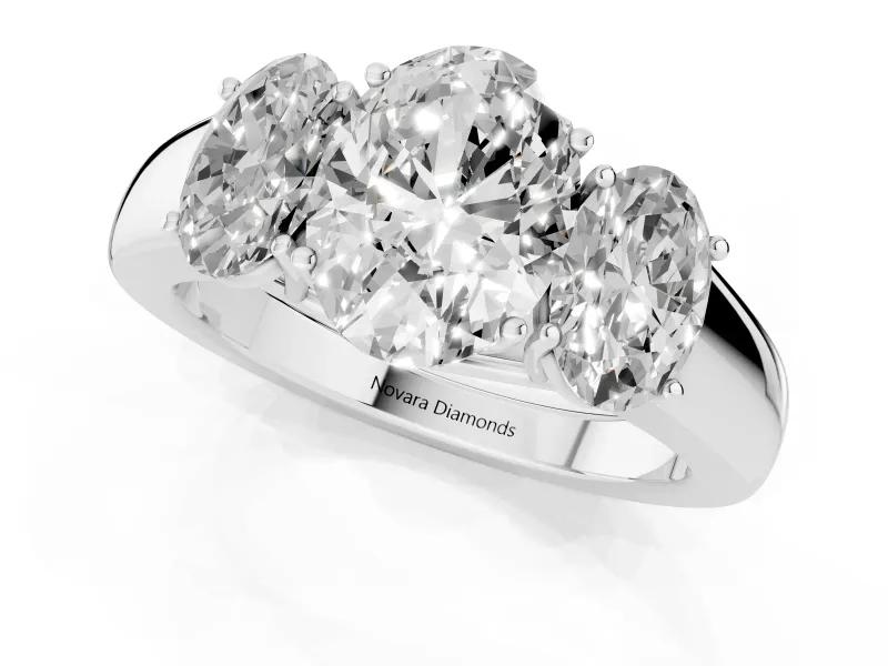 Three-Stone Oval Cut Diamond Ring Set in Platinum with Matching Prong Settings and Plain Band