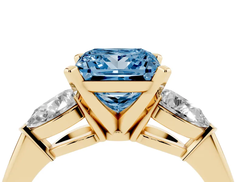 Fancy Blue Three-Stone Princess Cut Diamond Ring Set in Yellow gold with Pear Side Stones and Prong Setting