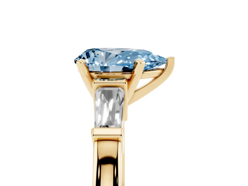 Fancy Blue Pear Cut Diamond Solitaire Ring Set in Yellow gold with Tapered Baguette Accents and Prong Setting