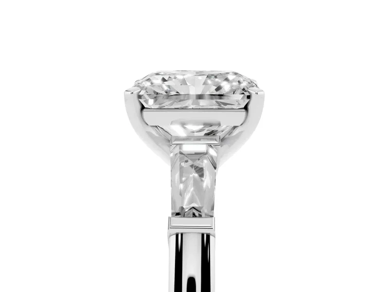 Radiant Cut Diamond Solitaire Ring Set in Platinum with Tapered Baguette Side Stones and Prong Setting