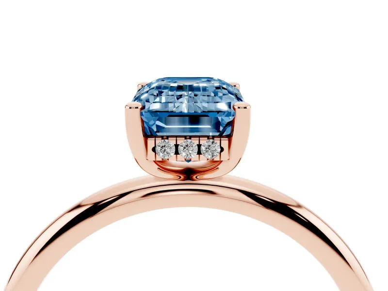 Fancy Blue Emerald Cut Diamond Solitaire Engagement Ring Set in Rose gold with Prong Setting and Polished Band