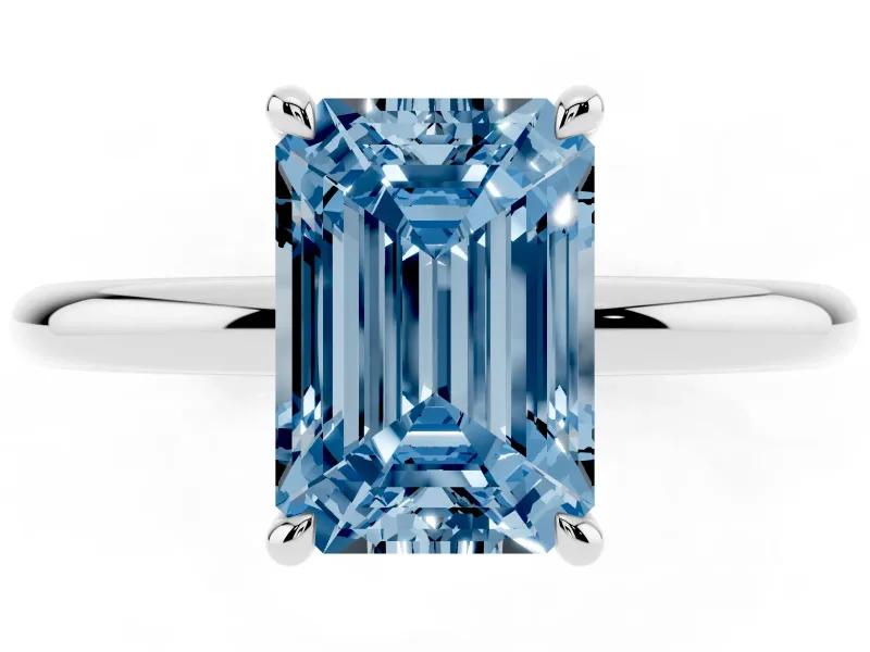 Fancy Blue Emerald Cut Diamond Solitaire Ring Set in White gold with Thin Band and Prong Setting