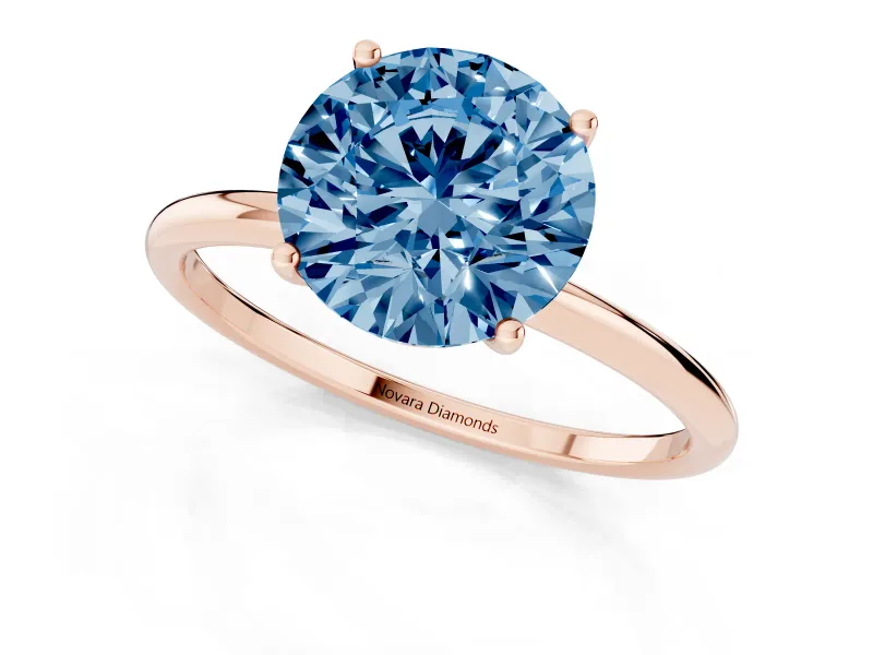 Fancy Blue Round Cut Diamond Solitaire Engagement Ring Set in Rose gold with Thin Band and Prong Setting