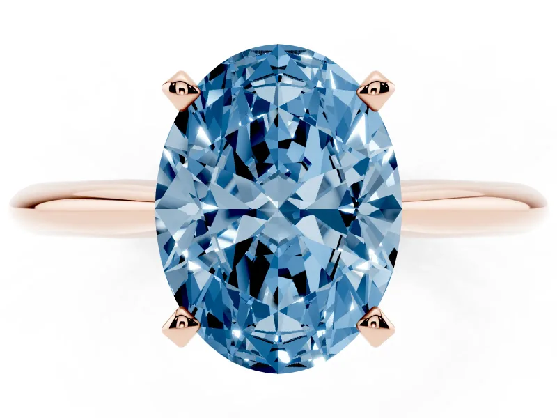 Fancy Blue Oval Cut Diamond Solitaire Ring Set in Rose gold with Prong Setting on a Plain Round Band