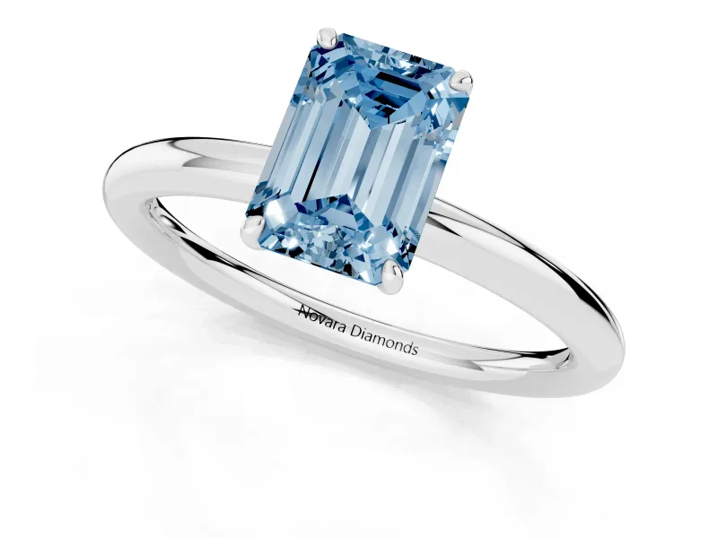 Fancy Blue Emerald Cut Diamond Solitaire Ring Set in Silver with Prong Setting on a Polished Plain Band