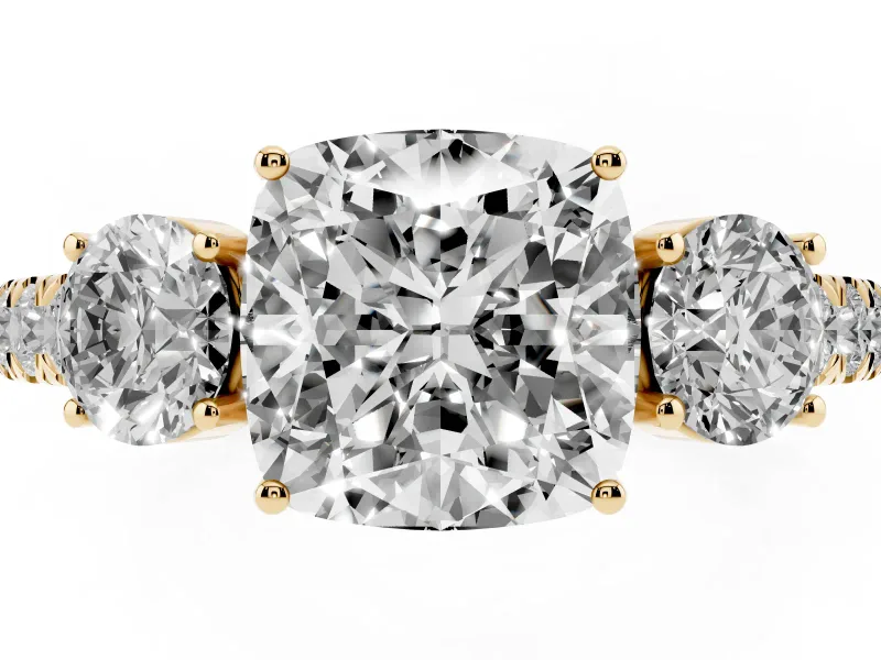Cushion Cut Diamond Three-Stone Ring Set in Yellow gold with Round Side Stones and Delicate Pavé Band