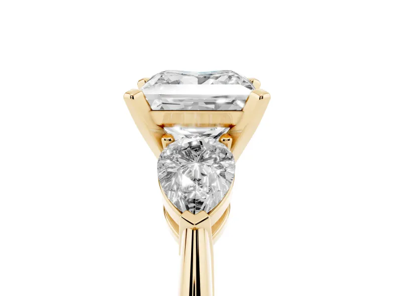 Three-Stone Princess Cut Diamond Ring Set in Yellow gold with Pear Side Stones and Prong Setting