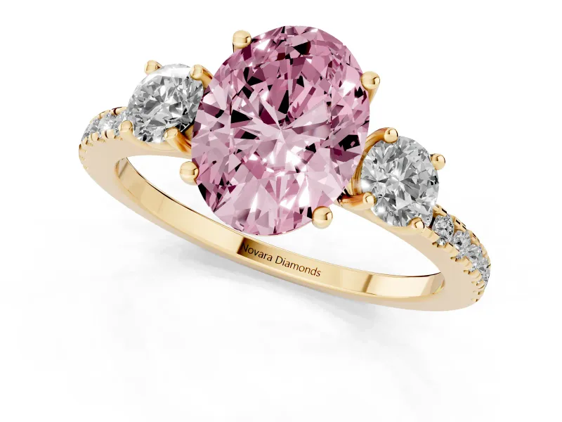 Fancy Pink Oval Cut Diamond Three-Stone Ring Set in Yellow gold with Pavé Band and Graduated Sides