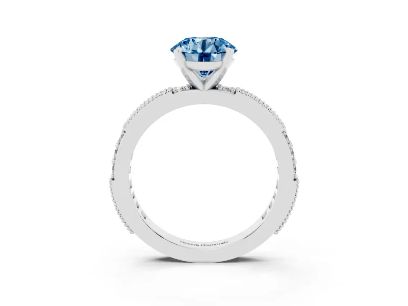 Fancy Blue Round Cut Diamond Solitaire Ring Set in White gold with Slim Pavé Band and Prong Setting