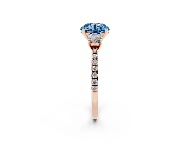 Fancy Blue Round Cut Diamond Three-Stone Ring Set in Rose gold with Pavé Band and Graduated Sides