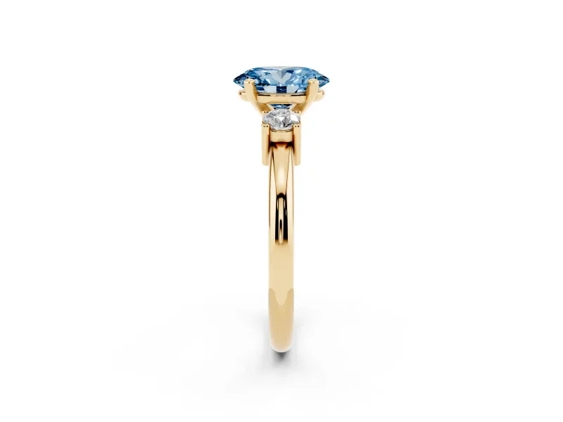 Fancy Blue Three-Stone Oval Cut Diamond Ring Set in Yellow gold with Prong Setting and Plain Band