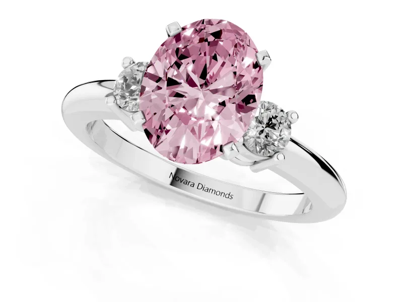 Fancy Pink Three-Stone Oval Cut Diamond Ring Set in White gold with Prong Setting and Plain Band