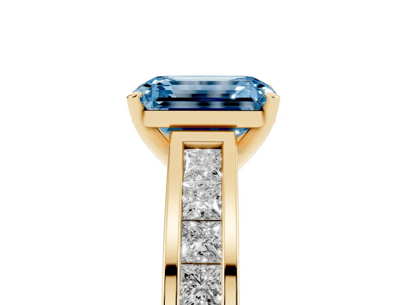 Fancy Blue Emerald Cut Diamond Solitaire Ring Set in Yellow gold with Channel-Set Band and Prong Setting