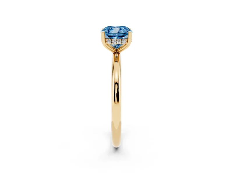 Fancy Blue Cushion Cut Diamond Solitaire Engagement Ring Set in Yellow gold with Prong Setting and Polished Band
