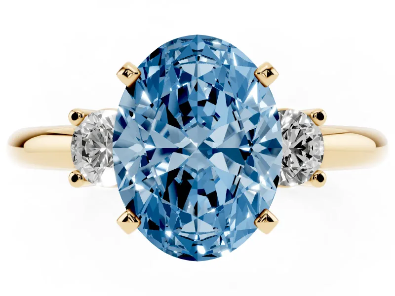 Fancy Blue Three-Stone Oval Cut Diamond Ring Set in Yellow gold with Prong Setting and Plain Band