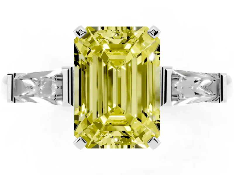 Fancy Yellow Emerald Cut Diamond Solitaire Ring Set in White gold with Tapered Baguette Side Stones and Prong Setting