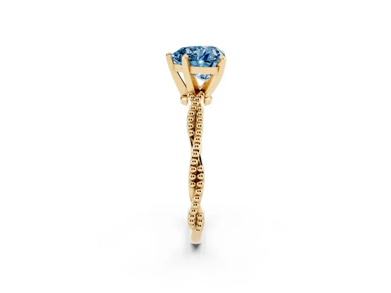 Fancy Blue Heart Cut Diamond Solitaire Ring Set in Yellow gold with Twisted Band and Bead Prong Setting