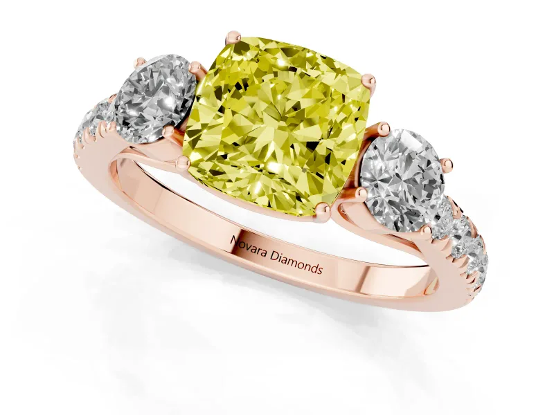 Fancy Yellow Cushion Cut Diamond Three-Stone Ring Set in Rose gold with Round Side Stones and Delicate Pavé Band