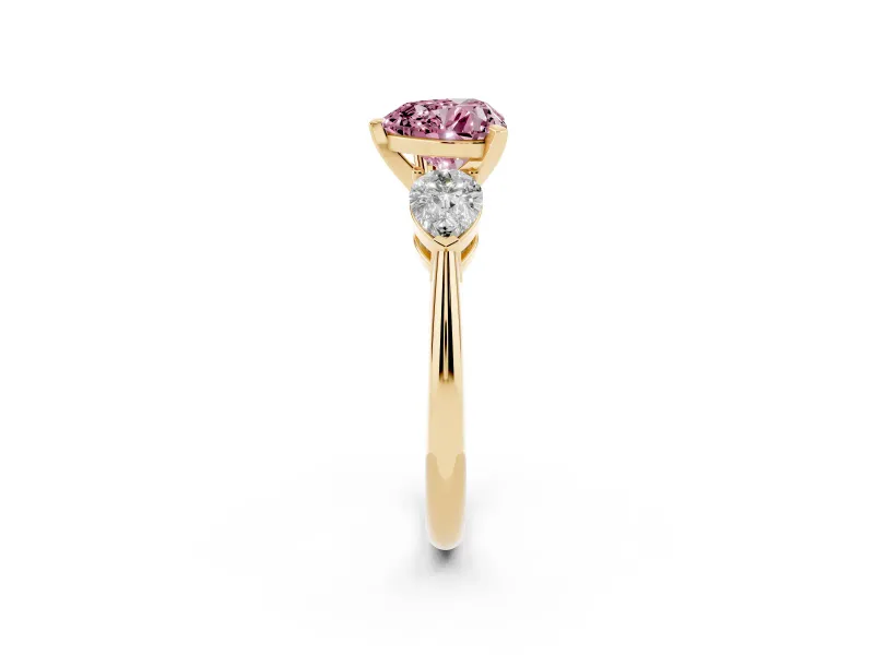 Fancy Pink Three-Stone Heart Cut Diamond Ring Set in Yellow gold with Pear Side Stones and Prong Setting