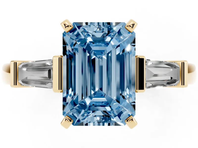 Fancy Blue Emerald Cut Diamond Solitaire Ring Set in Yellow gold with Tapered Baguette Accents and Prong Setting